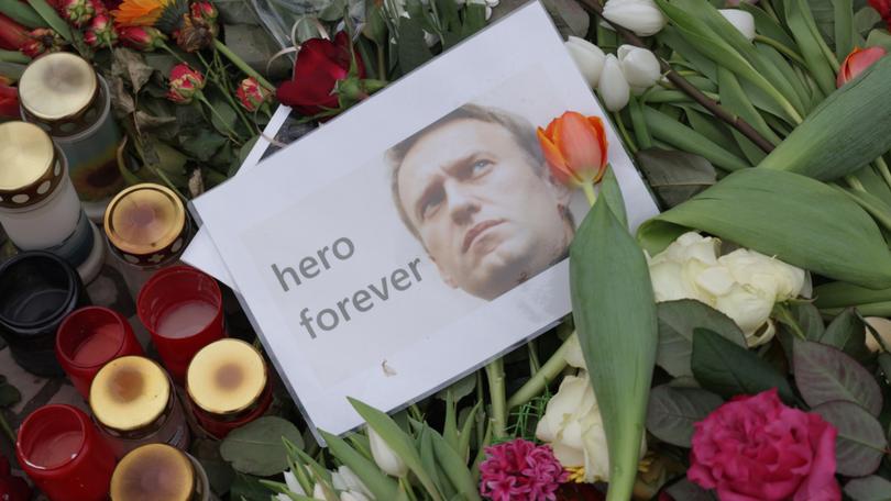 A photo of Russian opposition figure Aleksei Navalny laid in front of the Russian Embassy after his death.