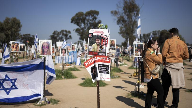 A poster depicting Israeli-American hostage Hersh Goldberg-Polin, centre, is displayed at a memorial at the site of the Nova music festival where he was kidnapped by Hamas.