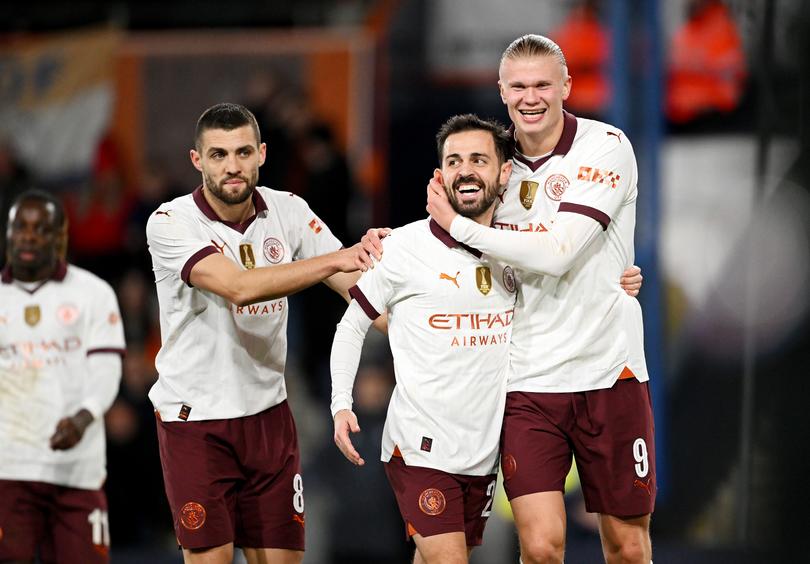 LUTON, ENGLAND - FEBRUARY 27: Erling Haaland of Manchester City celebrates scoring his team's fifth goal with teammate Bernardo Silva during the Emirates FA Cup Fifth Round match between Luton Town and Manchester City at Kenilworth Road on February 27, 2024 in Luton, England. (Photo by Shaun Botterill/Getty Images)