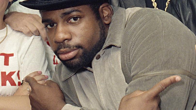 FILE -Run-D.M.C.'s Jason Mizell, Jam-Master Jay, poses with teenagers gathered at New York's Madison Square Garden, Oct. 7, 1986, in New York.  Two men were convicted of murder Tuesday, Feb. 27, 2024 in the death of Run-DMC star Jam Master Jay, a brazen 2002 shooting in the rap legend's studio. An anonymous Brooklyn federal jury delivered the verdict in the trial of Karl Jordan Jr. and Ronald Washington.(AP Photo/G. Paul Burnett, File)