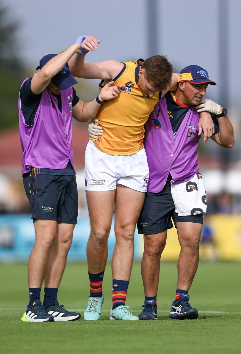 ADELAIDE, AUSTRALIA - FEBRUARY 23: Mark Keane of the Crows is helped off by trainers after a tackle by Willie Rioli and Sam Powell-Pepper of the Power causing a concussion during an AFL practice match between Port Adelaide Power and Adelaide Crows at Alberton Oval on February 23, 2024 in Adelaide, Australia. (Photo by Mark Brake/Getty Images)