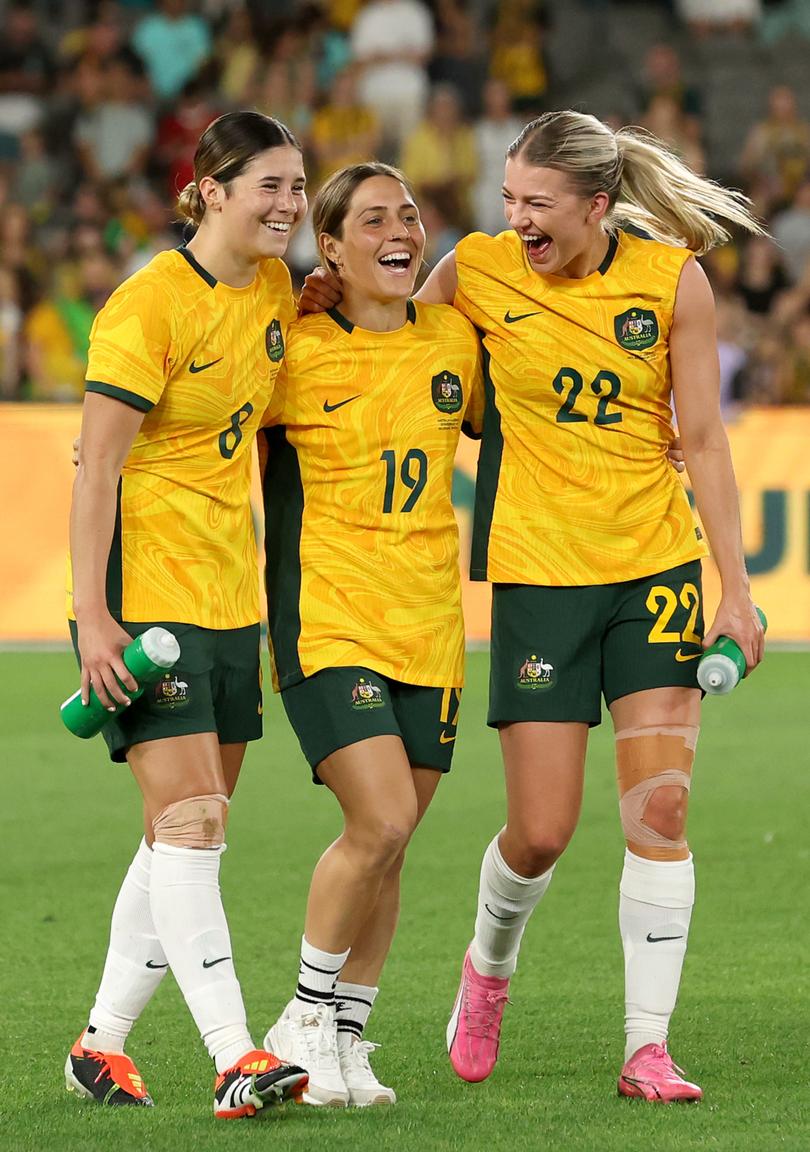 Kyra Cooney-Cross , Katrina Gorry and Charlotte Grant celebrate the win.