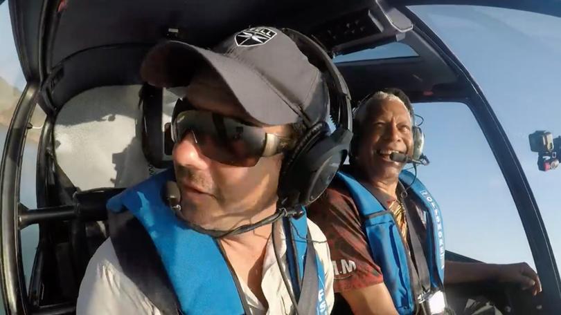 Troy Thomas flying with Ernie Dingo.