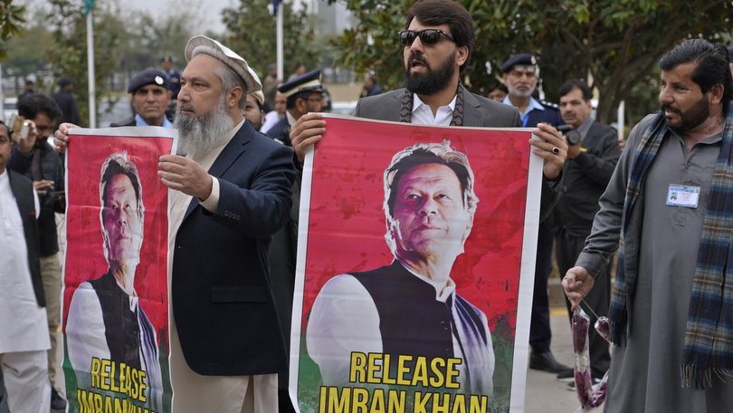 MPs have waved posters of their jailed leader Imran Khan as they arrived at parliament. (AP PHOTO)