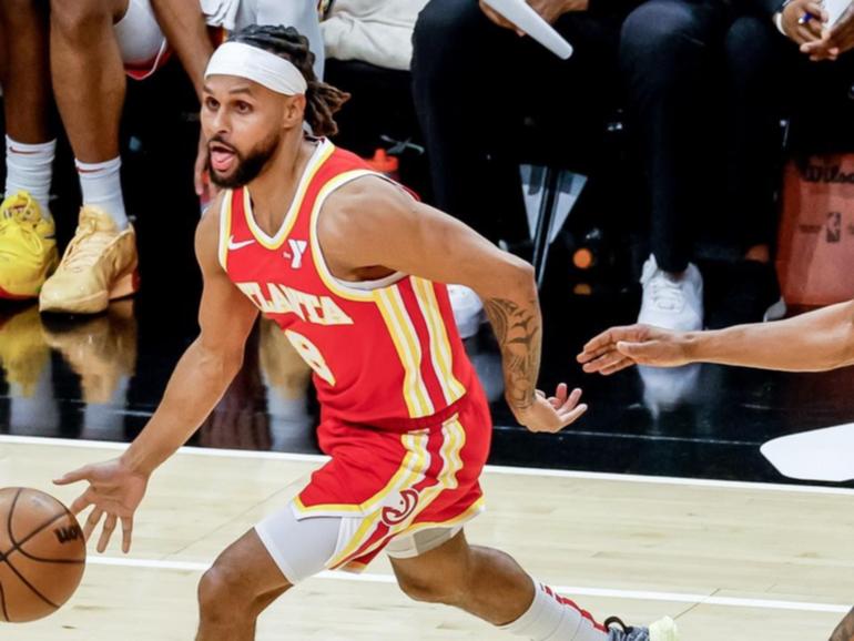 Patty Mills, on the ball against Phoenix, has been waived by the NBA's Atlanta Hawks. (EPA PHOTO)