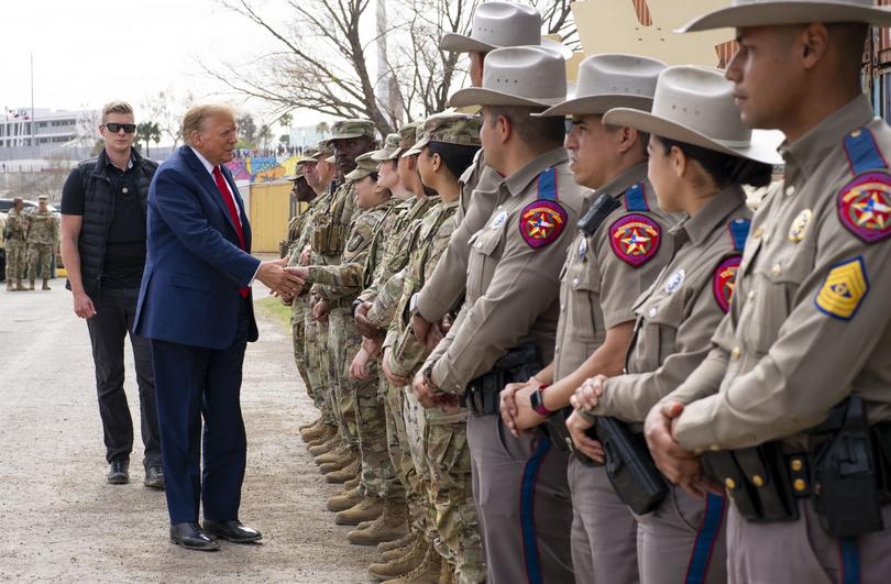 Former President Donald Trump greets Army personnel and members of the Texas Highway Patrol during his visit.