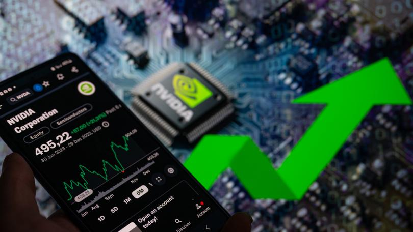 A smart phone is displaying the NVIDIA Corporation stock price on the NASDAQ market, with an NVIDIA chip visible in the background, in this photo illustration taken in Brussels, Belgium, on December 30, 2023. (Photo by Jonathan Raa/NurPhoto via Getty Images)