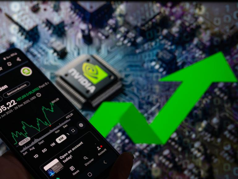 A smart phone is displaying the NVIDIA Corporation stock price on the NASDAQ market, with an NVIDIA chip visible in the background, in this photo illustration taken in Brussels, Belgium, on December 30, 2023. (Photo by Jonathan Raa/NurPhoto via Getty Images)