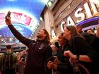 Brisbane’s Pat Carrigan takes a selfie with fans during the NRL season launch at Fremont Street Experience in Las Vegas. (Photo by Ezra Shaw/Getty Images)