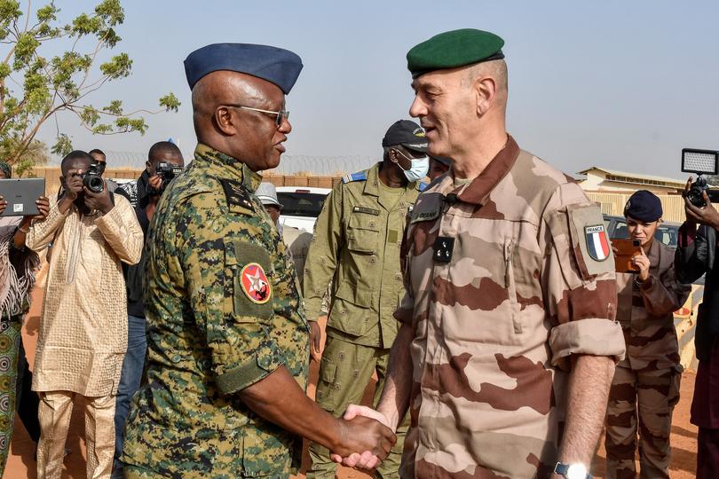 General Eric Ozanne (R), commander of French forces in the Sahel chakes hands with the Chief of staff of the Armies of Togo (L), mediating in the process of withdrawal of French soldiers in Niger, at the French base which was handed over to the Nigerien army, in Niamey on December 22, 2023. The last French troops withdrew from Niger on December 22, 2023, marking an end to more than a decade of French anti-jihadist operations in west Africa's Sahel region, AFP saw and Niger's military announced.
The French exit from Niger leaves hundreds of US military personnel, and a number of Italian and German troops, remaining in the country. (Photo by BOUREIMA HAMA / AFP)