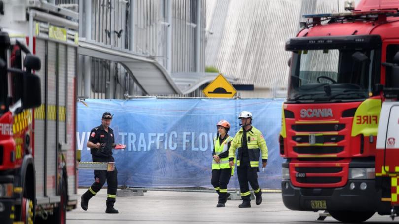 Emergency crews onsite near a sinkhole that caused a building to sag in the middle.
