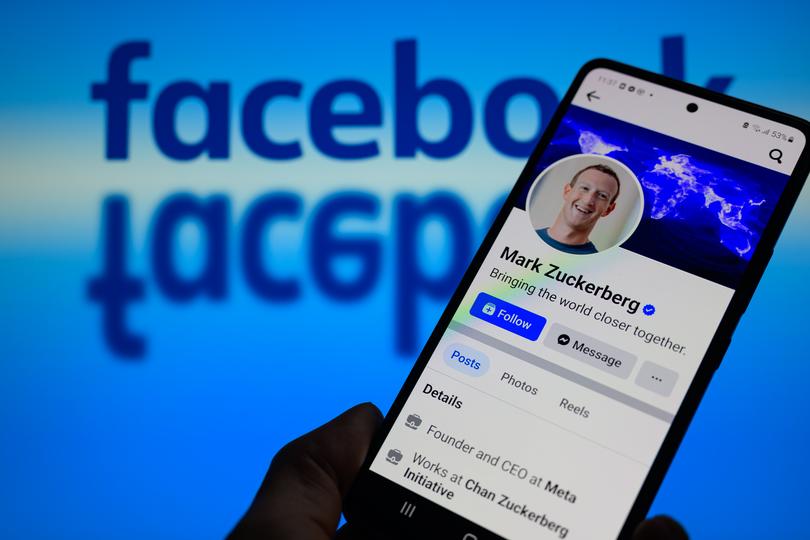 Mark Zuckerberg's Facebook page is being displayed on a smartphone with Facebook visible in the background, illustrating the platform that was founded 20 years ago. This photo illustration was taken in Brussels, Belgium, on February 3, 2024. (Photo by Jonathan Raa/NurPhoto via Getty Images)