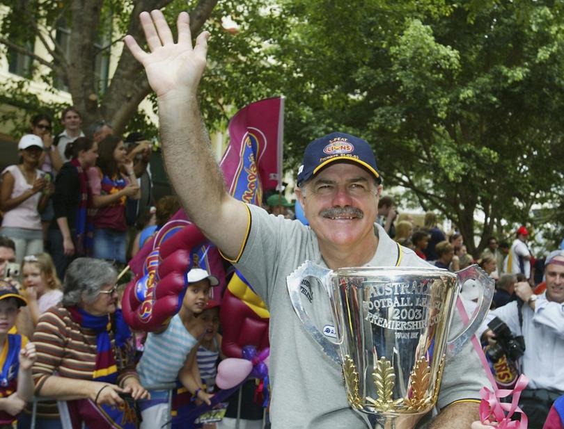 Leigh Matthews coach of the Lions waves to the crowd during the Brisbane Lions AFL Premiership victory street parade September 30, 2003 in Brisbane, Australia.