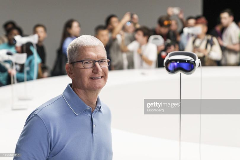 Tim Cook, chief executive officer of Apple Inc., beside an Apple Vision Pro mixed reality (XR) headset during the Apple Worldwide Developers Conference at Apple Park campus in Cupertino, California, US, on Monday, June 5, 2023. Apple Inc. will charge $3,499 for its long-awaited mixed-reality headset, testing whether consumers are ready to spend big bucks on a technology that the company sees as the future of computing. Photographer: Philip Pacheco/Bloomberg via Getty Images