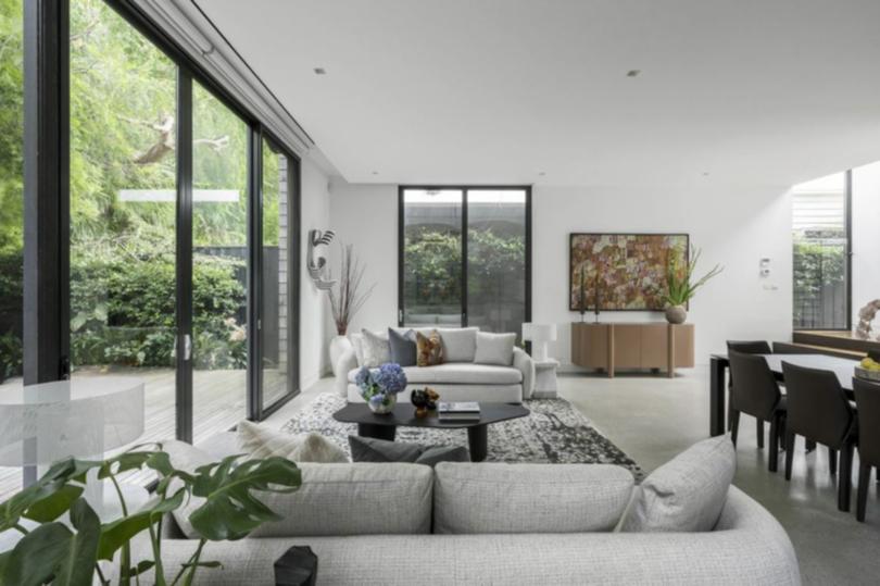 Sliding doors in the living room connect to the deck and garden.