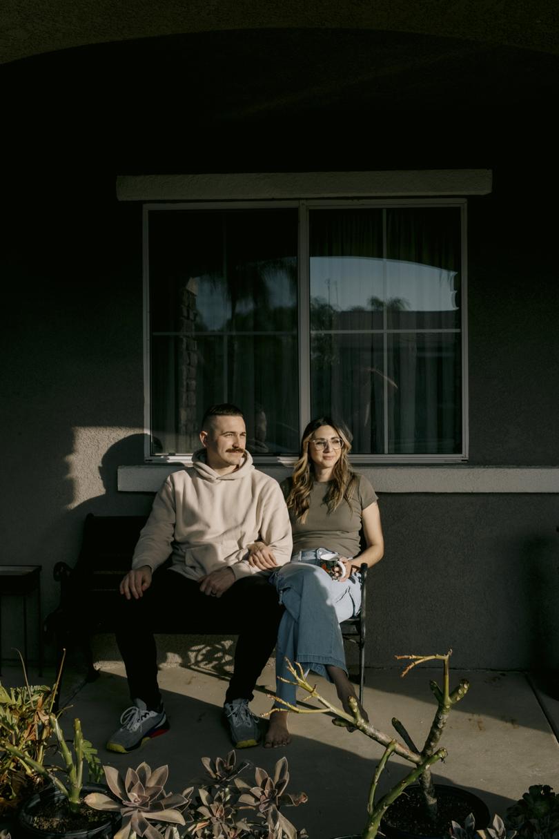Bartender Spencer Holbrook, 32, and his wife Rebeccah, outside her parents home, where the couple and their two young children live, in Corona, Calif.