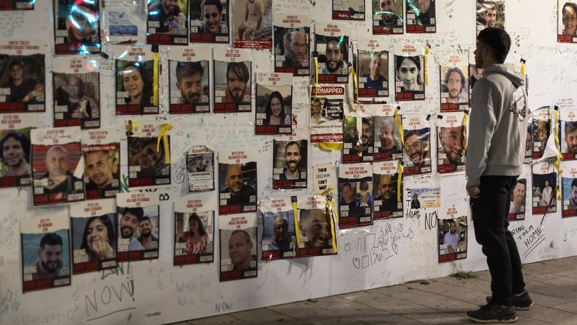 Placards showing the Israeli hostages held by Hamas are seen near hostage square on December 26, 2023 in Tel Aviv.