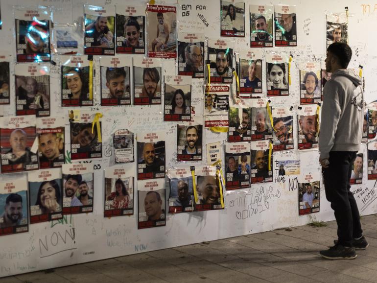 Placards showing the Israeli hostages held by Hamas are seen near hostage square on December 26, 2023 in Tel Aviv.