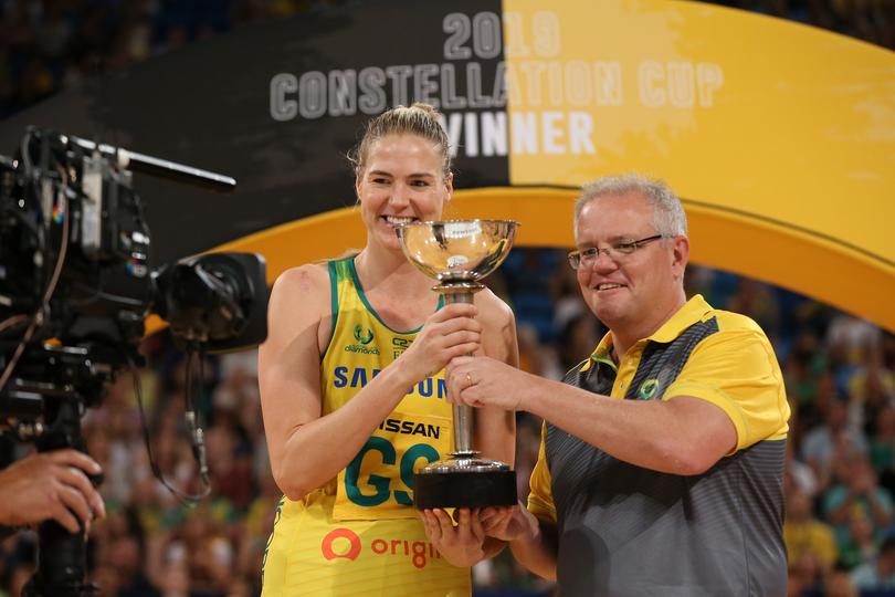 PERTH, AUSTRALIA - OCTOBER 27: Australian Prime Minister Scott Morrison presents the Constellation Cup to Caitlin Bassett of Australia during the 2019 Constellation Cup match between the Australia Diamonds and the New Zealand Silver Ferns at RAC Arena on October 27, 2019 in Perth, Australia. (Photo by Paul Kane/Getty Images)