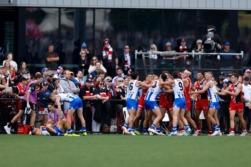 Players remonstrate as Jy Simpkin of the Kangaroos lays injured.