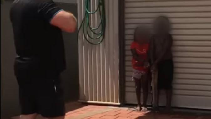 A man has been arrested after he was filmed restraining two Aboriginal children with cable ties outside a Broome home on Tuesday.