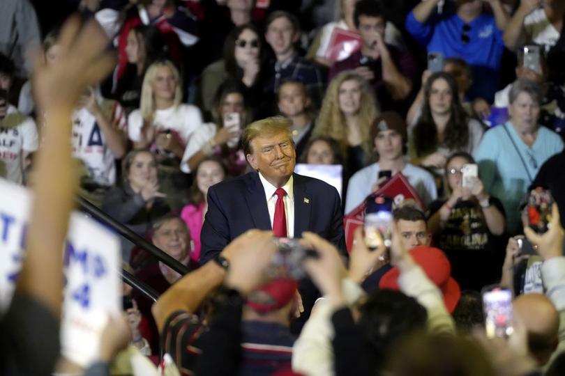 Republican presidential candidate former President Donald Trump interacts with supporters.