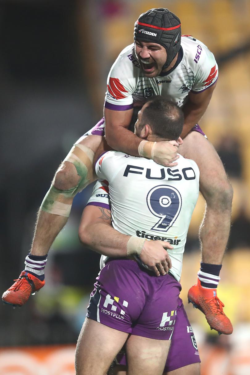 AUCKLAND, NEW ZEALAND - JUNE 08: Jesse Bromwich of the Storm is congratulated by Cameron Smith and Jahrome Hughes after scoring a try during the round 13 NRL match between the New Zealand Warriors and the Melbourne Storm at Mt Smart Stadium on June 08, 2019 in Auckland, New Zealand. (Photo by Phil Walter/Getty Images)