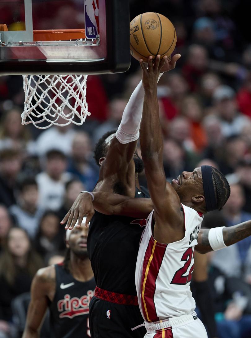 Miami Heat forward Jimmy Butler, right, shoots over Portland Trail Blazers center Deandre Ayton during the first half of an NBA basketball game in Portland, Ore., Tuesday, Feb. 27, 2024. (AP Photo/Craig Mitchelldyer)