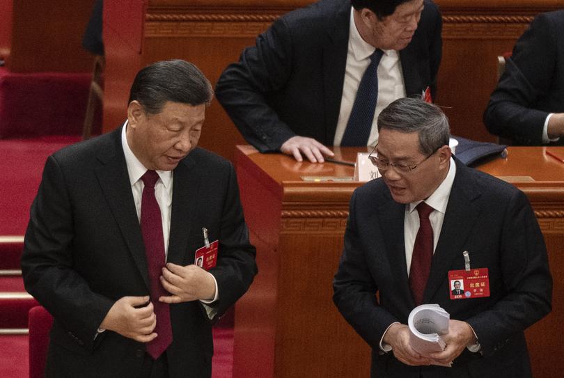 BEIJING, CHINA - MARCH 5: Chinese President Xi Jinping (L) speaks to Premier Li Qiang at the opening of the NPC, or National People's Congress, at the Great Hall of the People on March 5, 2024 in Beijing, China. China's annual political gathering known as the Two Sessions will convene leaders and lawmakers to set the government's agenda for domestic economic and social development for the year. (Photo by Kevin Frayer/Getty Images)