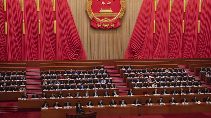 Chinese Premier Li Qiang stands at the podium during his speech at the opening of the National People's Congress, at the Great Hall of the People on Tuesday.