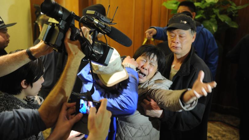 A family member of a passenger from the missing Malaysia Airlines flight MH370 reacts at Lido Hotel on March 24, 2014 in Beijing, China. 