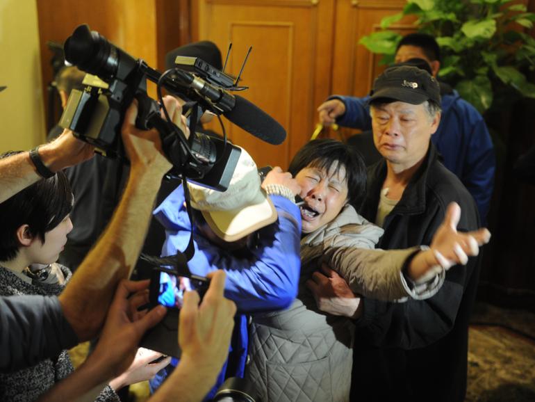 A family member of a passenger from the missing Malaysia Airlines flight MH370 reacts at Lido Hotel on March 24, 2014 in Beijing, China. 