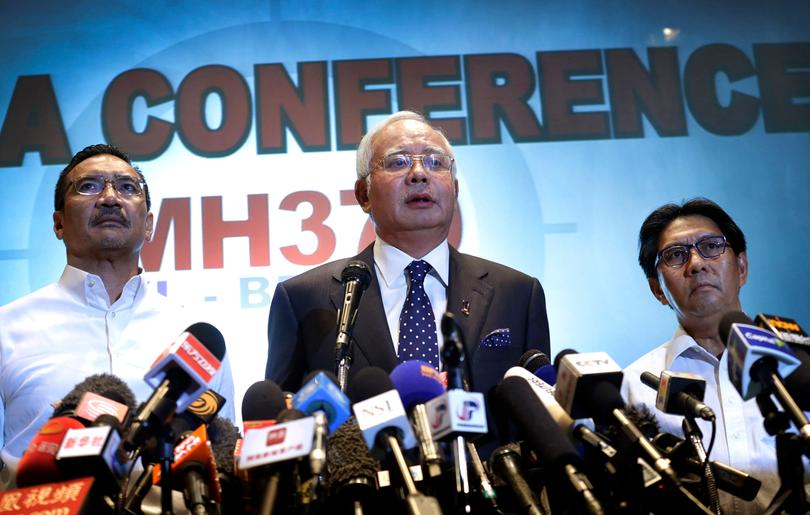 Malaysian Prime Minister Najib Razak, centre, Malaysia's Minister for Transport Hishamuddin Hussein, left, and director general of the Malaysian Department of Civil Aviation, Azharuddin Abdul Rahman, delivers a statement to the media.