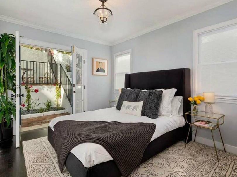 One of the home's two bedrooms with French doors leading out to the courtyard.