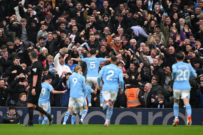 LIVERPOOL, ENGLAND - MARCH 10: John Stones of Manchester City celebrates scoring his team's first goal with the fans during the Premier League match between Liverpool FC and Manchester City at Anfield on March 10, 2024 in Liverpool, England. (Photo by Michael Regan/Getty Images)