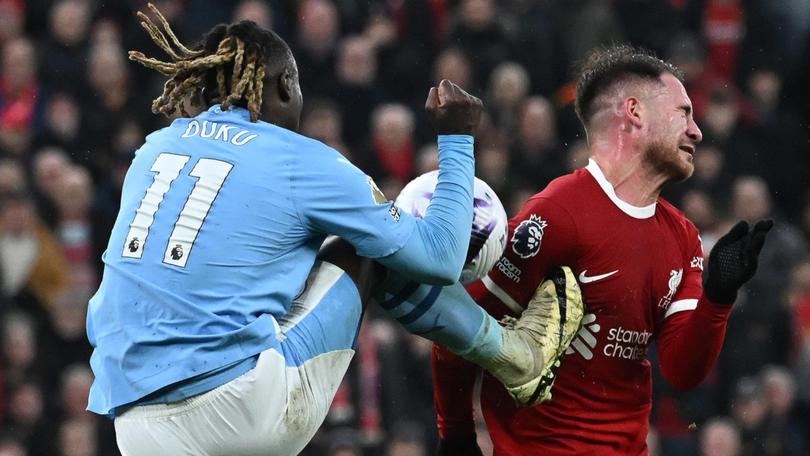 Manchester City's midfielder Jeremy Doku kicks Liverpool's midfielder Alexis Mac Allister during the dying minutes of the 1-1 draw.