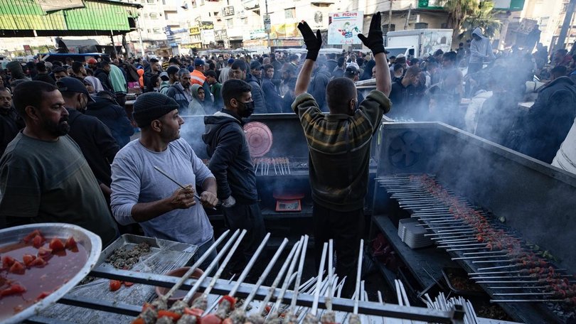 Palestinians prepare food on the first day of Ramadan in the south of the Gaza Strip. (EPA PHOTO)