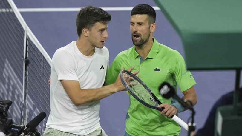 Italian Luca Nardi, left, has stunned Novak Djokovic in a third-round upset in Indian Wells.