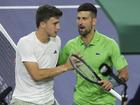 Italian Luca Nardi, left, has stunned Novak Djokovic in a third-round upset in Indian Wells.