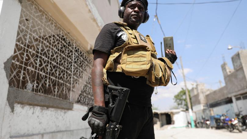 Former police officer Jimmy "Barbecue" Cherizier, and leader of an alliance of armed groups, holds a press conference.