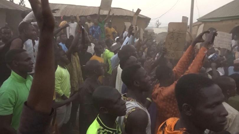 This video grab taken shows families of abducted pupils gathering during the visit of the Kaduna State governor Uba Sani after gunmen kidnapped 268 students and staff from a school in Kuriga. 