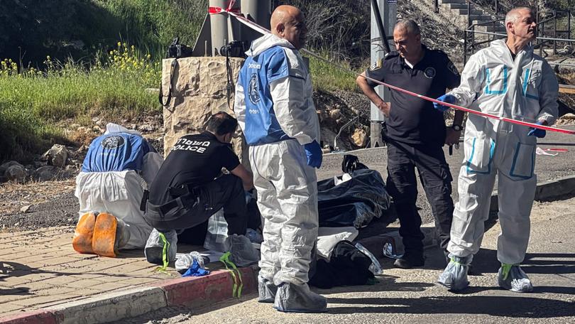 Israeli forces work at the scene of a suspected attack at a checkpoint outside of Jerusalem.