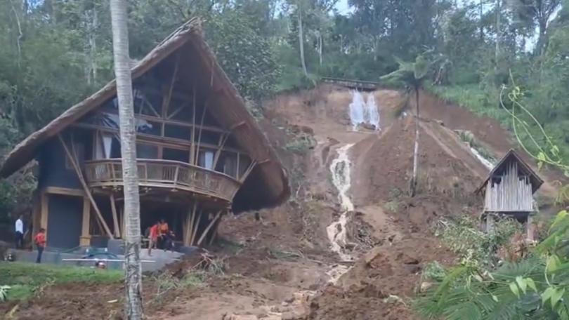An Australian woman is among two tourists who have been killed in Bali after heavy rain triggered a landslide that swept away their villa.