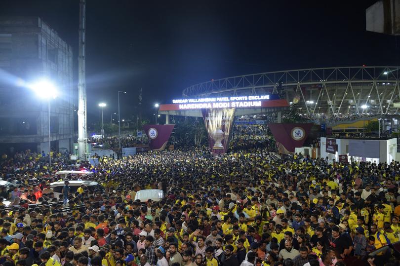 Cricket fans exit Narendra Modi Stadium after rains disrupted the IPL final between Chennai Super Kings and Gujarat Titans in Ahmedabad on May 29, 2023. 