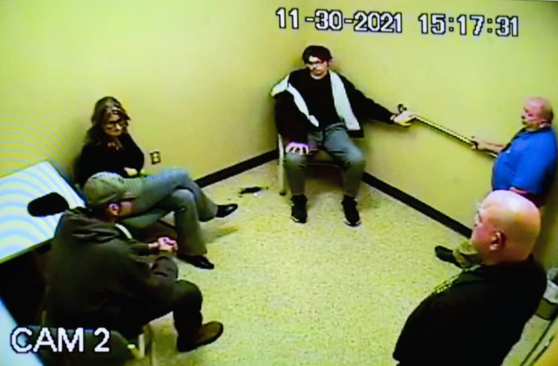 Police footage of James Crumbley, left, Jennifer Crumbley, centre, and Ethan Crumbley in an interview room at the Oakland County Sheriff’s Department in 2021.