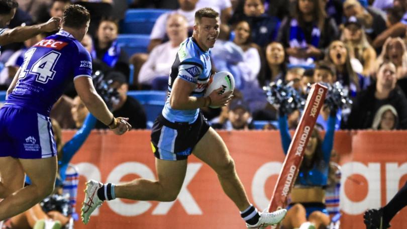 Cronulla's Teig Wilton scores a try during the Sharks' win over the Bulldogs.