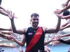 Zach Merrett of the Bombers high fives fans after winning round one. 