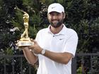 Scottie Scheffler shows off the trophy after defending his Players Championship title. (AP PHOTO)