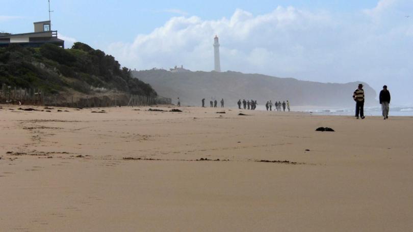 Three men were swimming at a beach off the Great Ocean Road when they got into trouble. 