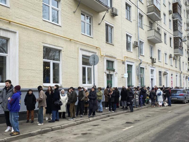 Voters queue at a polling station in Moscow